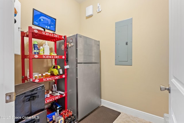 kitchen with tile patterned flooring, electric panel, and stainless steel refrigerator