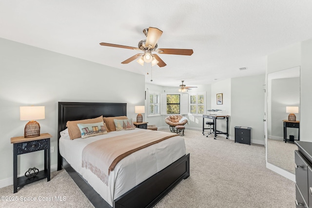 bedroom with ceiling fan and light colored carpet