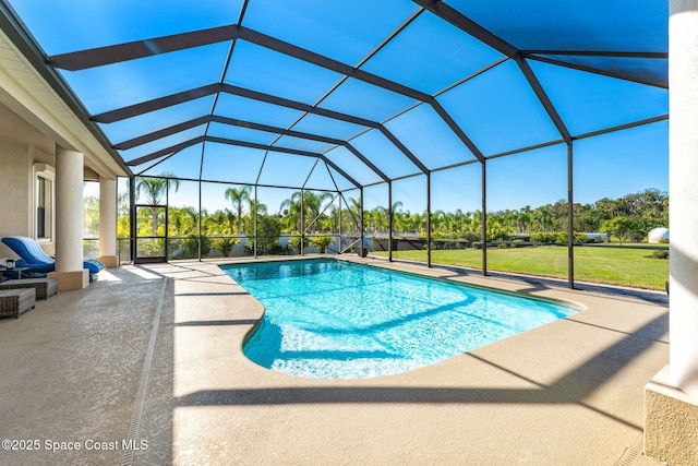 view of swimming pool featuring a lanai, a yard, and a patio area