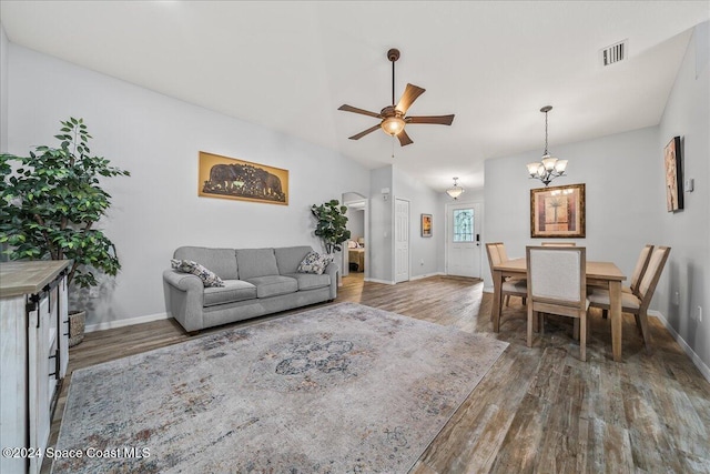 living room featuring ceiling fan with notable chandelier and hardwood / wood-style floors