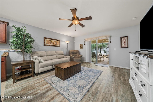 living room with ceiling fan and light hardwood / wood-style flooring