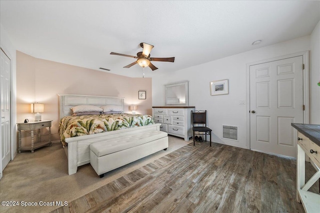 bedroom with dark hardwood / wood-style floors and ceiling fan