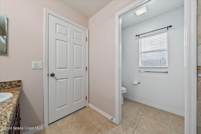 bathroom with tile patterned floors, vanity, and toilet