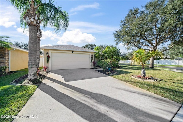 view of front of property with a garage and a front lawn