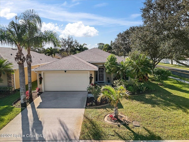 view of front of house with a garage and a front yard