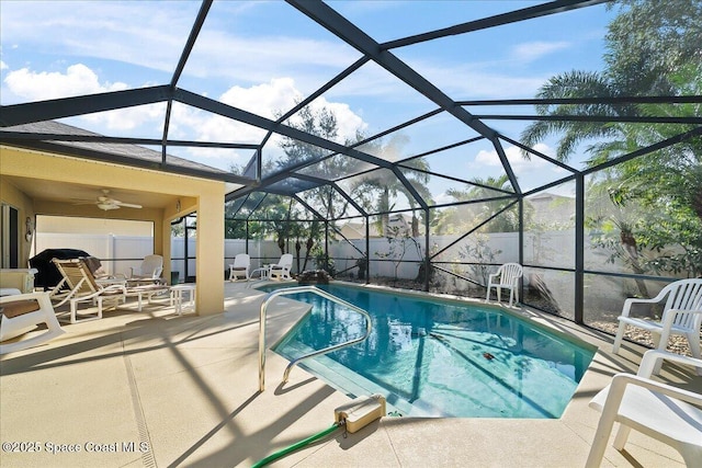 view of swimming pool featuring a lanai, ceiling fan, and a patio area