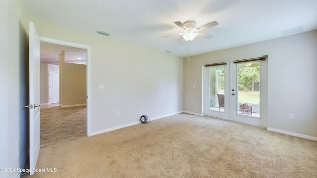 carpeted empty room with ceiling fan and french doors