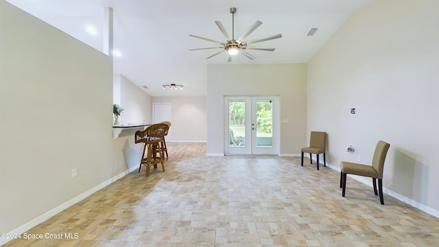 sitting room featuring ceiling fan and french doors