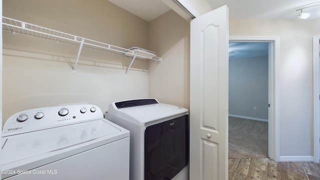 washroom featuring independent washer and dryer and light wood-type flooring