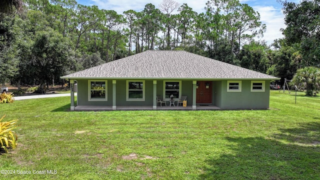 view of front of house with covered porch and a front yard