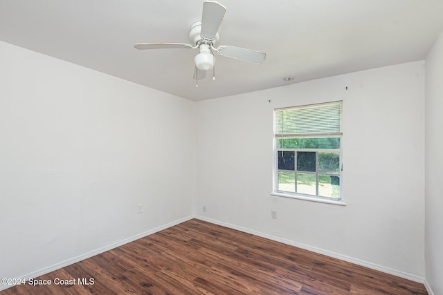 empty room with ceiling fan and dark hardwood / wood-style floors