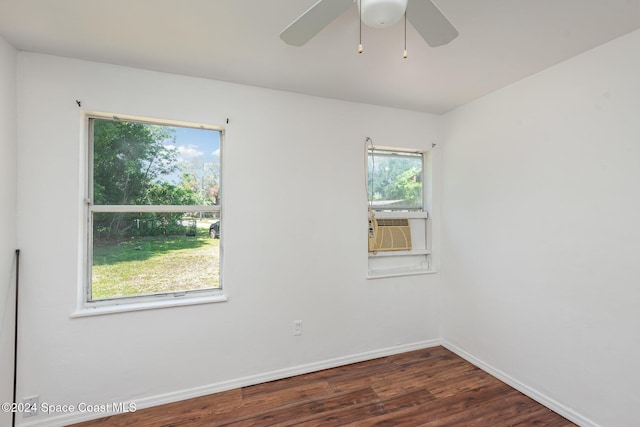 spare room featuring dark hardwood / wood-style flooring, plenty of natural light, cooling unit, and ceiling fan