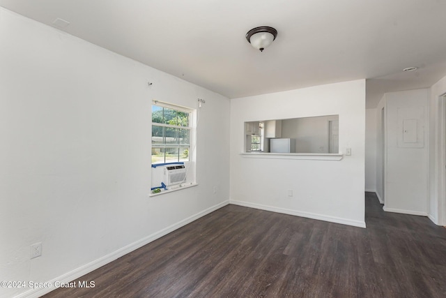 unfurnished room with cooling unit and dark wood-type flooring