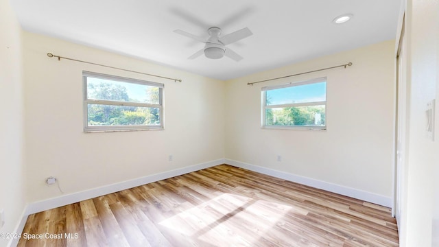 empty room with light hardwood / wood-style flooring and ceiling fan