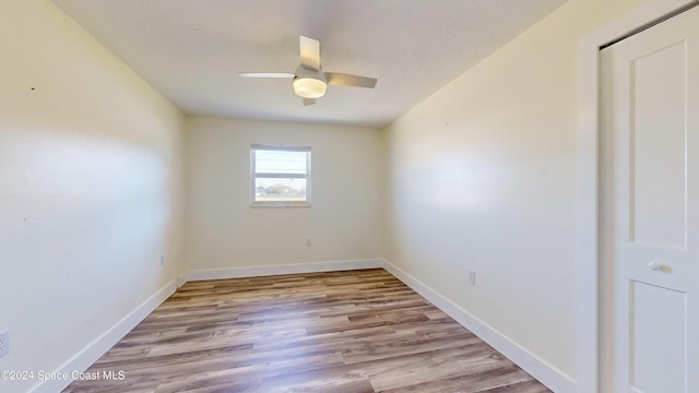 unfurnished room with light wood-type flooring and ceiling fan