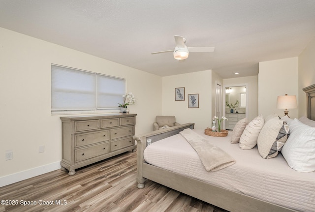 bedroom with light wood-type flooring, ensuite bathroom, and ceiling fan