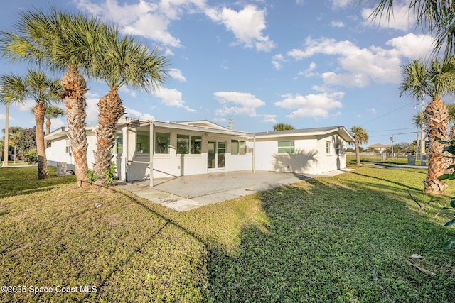 rear view of property with a patio area and a yard