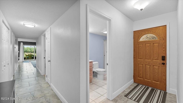 entryway featuring a textured ceiling