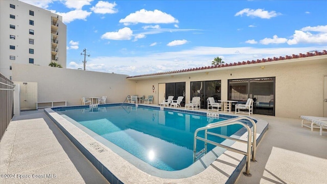 view of swimming pool with a patio area