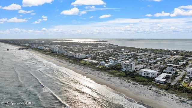 drone / aerial view featuring a water view and a view of the beach