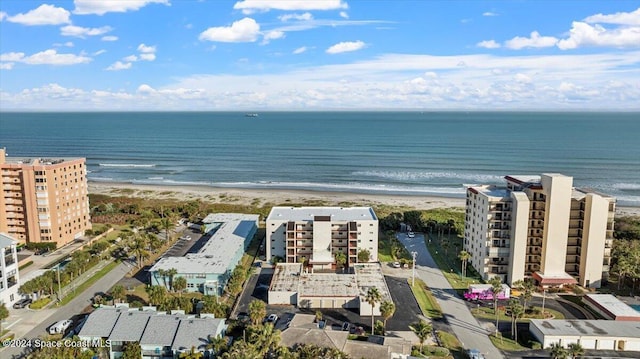 drone / aerial view featuring a water view and a beach view