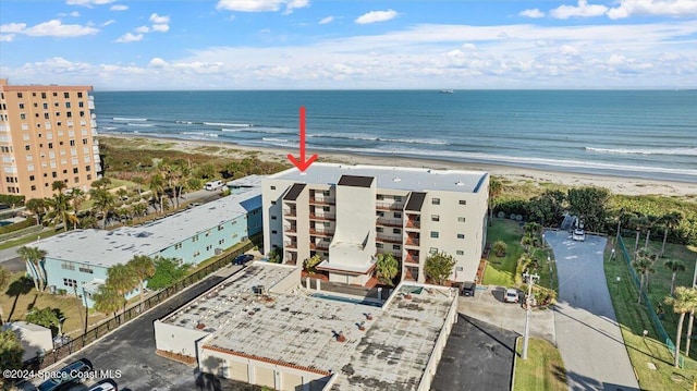 drone / aerial view with a water view and a view of the beach