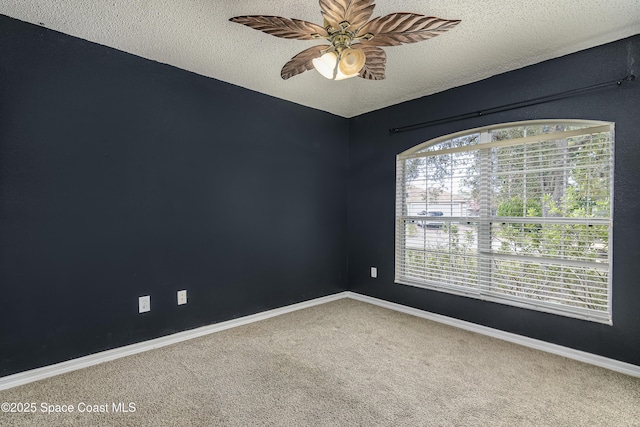 unfurnished room featuring ceiling fan, carpet floors, and a textured ceiling