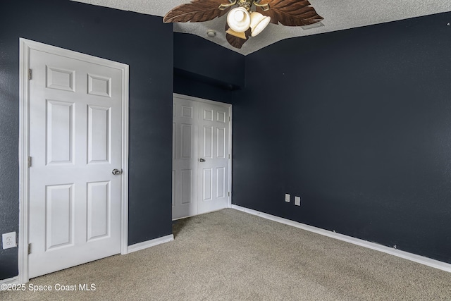 unfurnished bedroom featuring ceiling fan, carpet flooring, a closet, and a textured ceiling