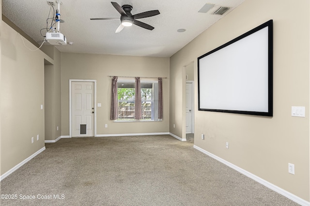 cinema featuring ceiling fan, a textured ceiling, and carpet