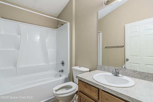 full bathroom with shower / washtub combination, vanity, a textured ceiling, and toilet