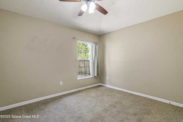 carpeted empty room with ceiling fan and a textured ceiling