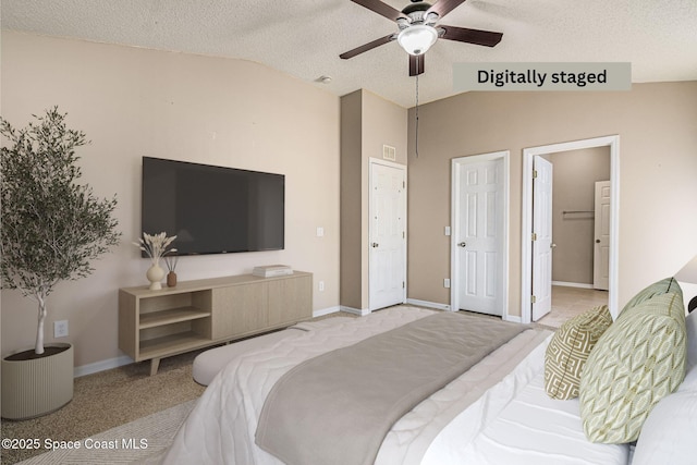 bedroom with lofted ceiling, light colored carpet, and a textured ceiling