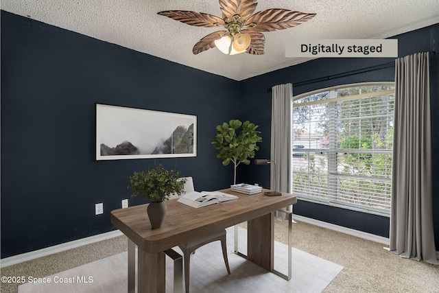 home office featuring ceiling fan, carpet flooring, and a textured ceiling