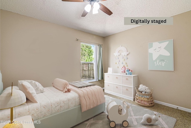 carpeted bedroom featuring ceiling fan and a textured ceiling