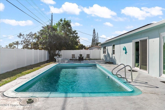 view of swimming pool featuring a patio area