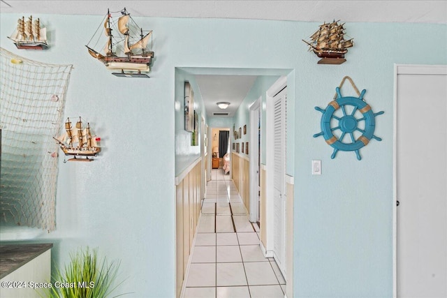 hall with light tile patterned floors