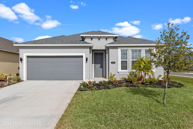 view of front of home with a garage and a front lawn