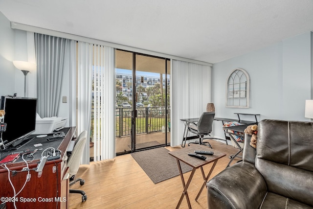 office featuring floor to ceiling windows and hardwood / wood-style floors