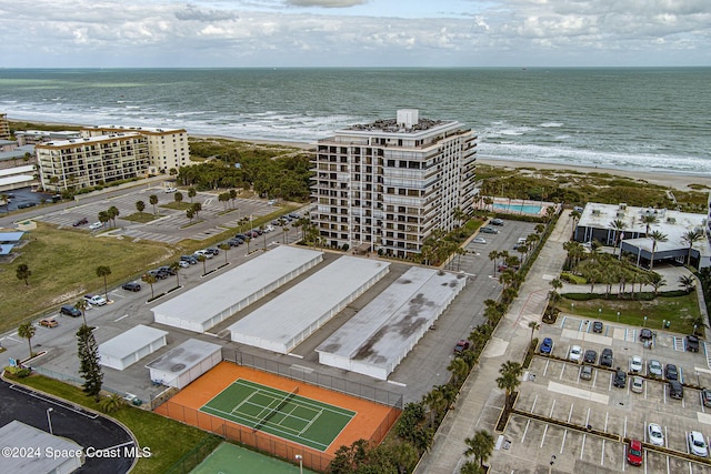 birds eye view of property featuring a water view and a beach view