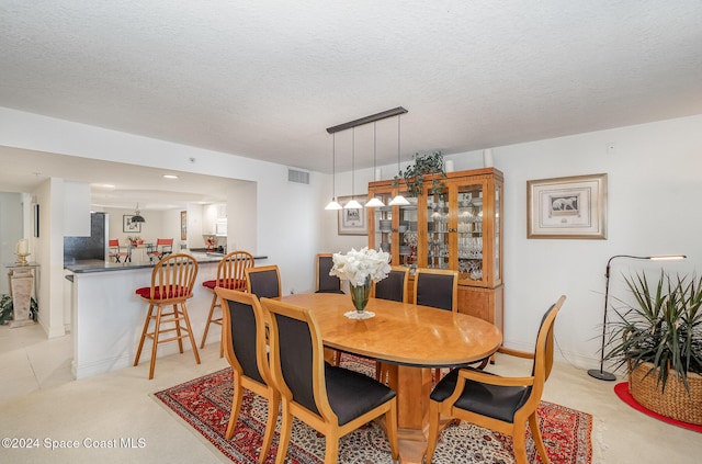 dining space with a textured ceiling