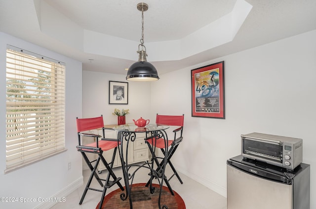 dining space featuring a tray ceiling