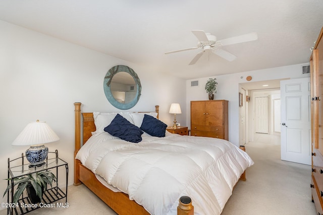 bedroom with ceiling fan and light carpet