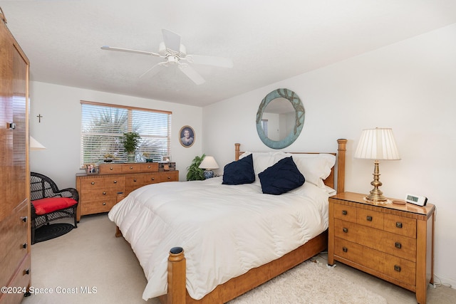 bedroom featuring light colored carpet and ceiling fan