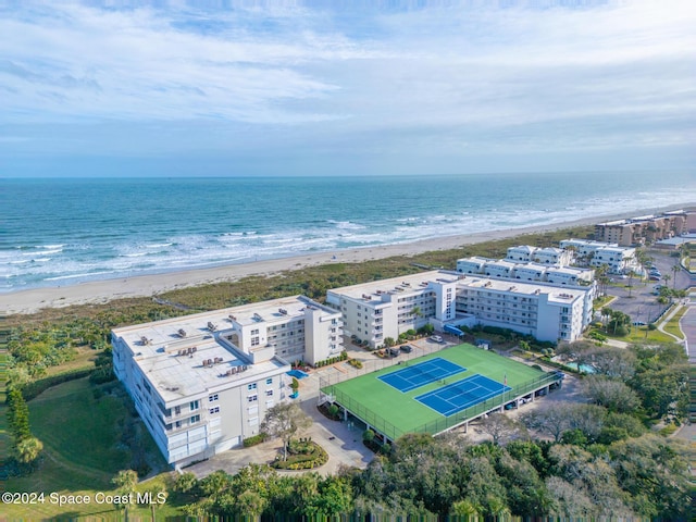 birds eye view of property featuring a beach view and a water view