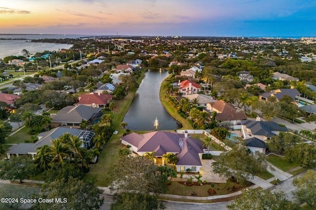 aerial view at dusk with a water view