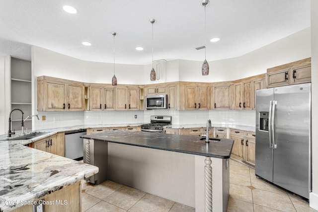 kitchen featuring sink, stainless steel appliances, dark stone countertops, pendant lighting, and decorative backsplash