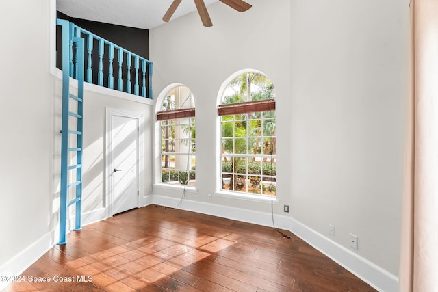 entrance foyer with ceiling fan, high vaulted ceiling, and hardwood / wood-style flooring