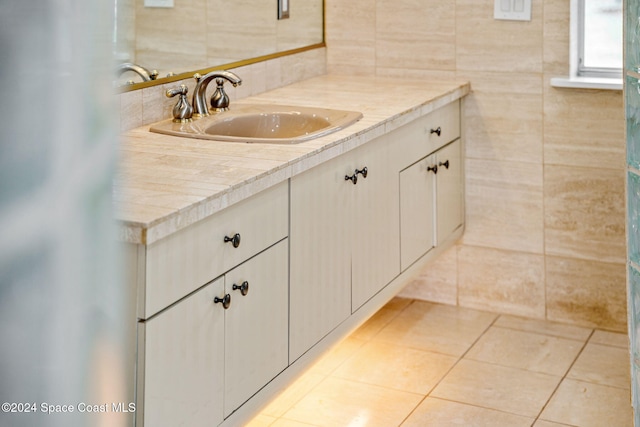 bathroom with vanity, tile patterned floors, and tile walls