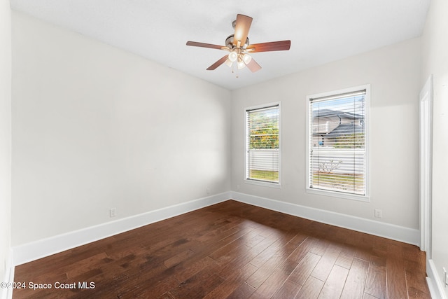 spare room featuring ceiling fan and dark hardwood / wood-style flooring