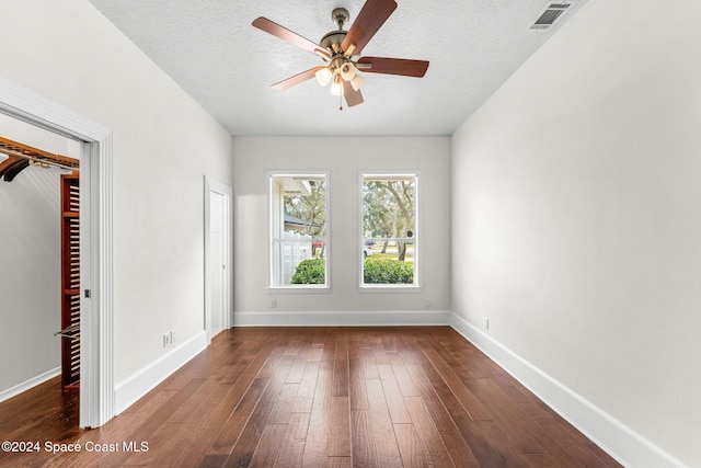 spare room with hardwood / wood-style floors, ceiling fan, and a textured ceiling